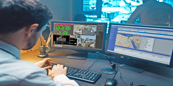 Security guard watching video monitoring surveillance security system.